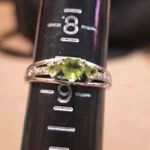 Sterling silver Peridot with small diamonds.